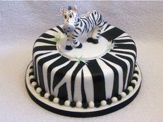 a zebra on top of a black and white cake