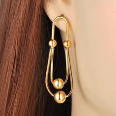 Material: Stainless Steel, Gold Plated Size: 2 inch by 0.7 inch (5.2 cm by 1.7 cm) Weight per pair: 0.4 oz (11 g) Design: Balls on a Chain Dangle Drop Earrings Color: Yellow Gold Travel Inspired Jewelry, G Design, Travel Inspired, Plate Size, Earrings Color, Dangle Drop Earrings, Gold Plate, Product Launch, Size 2