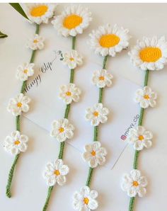 crocheted daisies are arranged on top of each other to make a flower garland