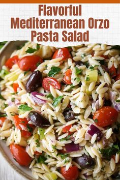 a bowl full of pasta salad with tomatoes, olives and parmesan cheese