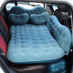 an inflatable car bed is placed inside the back of a vehicle with two air mattresses on it