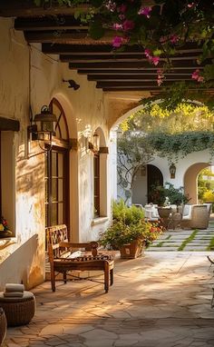 an outdoor patio with chairs and potted plants