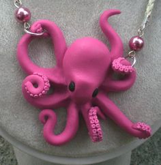 a pink octopus necklace on a mannequin