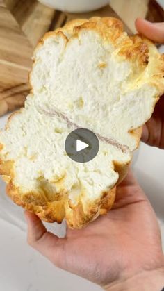 a person holding a piece of bread in their hand with the video title below it