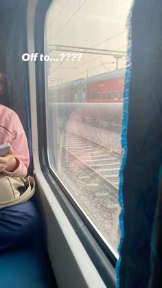 a woman sitting on a train looking at her cell phone