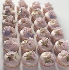 there are many small pink cupcakes with bows on the top and flowers on the bottom