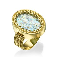 "This 14k gold ring is an alluring piece of jewelry set with ancient roman glass, cradled with a sun like intricate curved designed oval base. The deep hues of blue and green contrast the gold beautifully. The back of the ring is adorned with filigree. The end result is a captivating ancient style modern Israeli ring.  This exquisite 14K Gold Ring is adorned with elegant filigree detailing on the band and a captivating piece of Roman Glass gracefully framed at the center. This ring seamlessly co Graduation Ring, Graduation Rings, Ancient Roman Glass, Filigree Pattern, Pretty Rocks, Glass Ring, Roman Glass, Oval Ring, Evil Eye Pendant