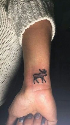 a small horse tattoo on the wrist