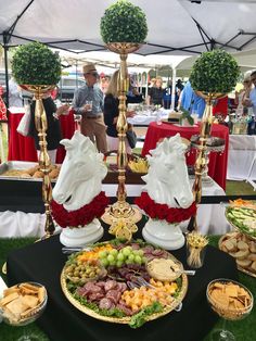 a table topped with lots of different types of food and desserts on plates next to each other