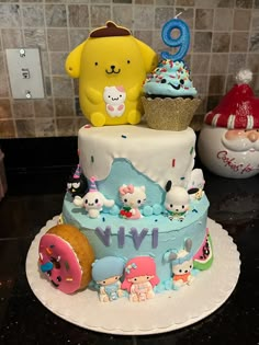 a birthday cake decorated with cartoon characters and decorations