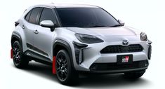 the front view of a white toyota suv with red stripes on it's side