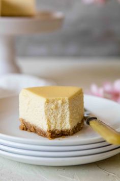 a piece of cheesecake sitting on top of a white plate next to a fork