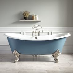 an old fashioned claw foot bathtub in a bathroom with white walls and flooring