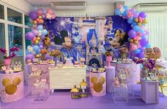 a room filled with balloons and decorations for a birthday party at the disney mouse theme park