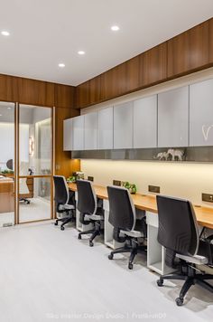 an office with chairs and desks in front of sliding glass doors that lead to the outside