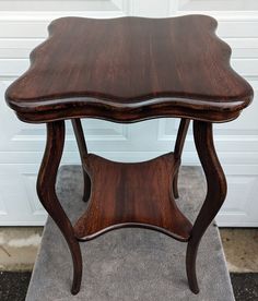 a wooden table sitting on top of a rug in front of a garage door,