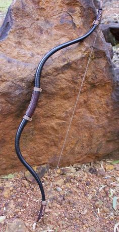 a long black hose attached to a rock