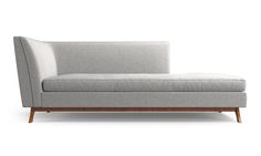 a white couch sitting on top of a wooden frame