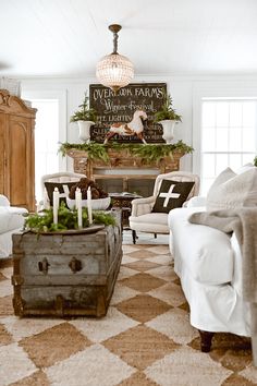 a living room filled with furniture and a fire place covered in greenery next to a fireplace