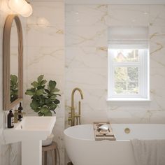 a white bath tub sitting next to a sink under a window with a potted plant