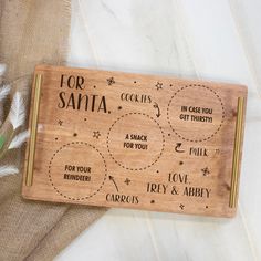 a personalized wooden tray with instructions for santa and other things to do on it