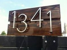 a large wooden sign with the number thirteen on it's front and back sides