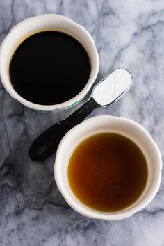 two cups of coffee on a marble table