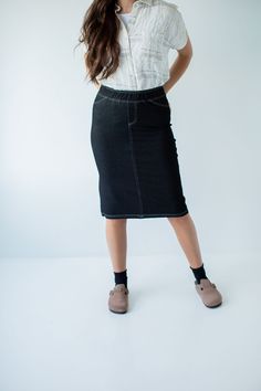 With the look of real denim but the feel of a quality knit, comfort is the key element in our exclusively designed 'Piper 'Skirt. The quick, pull on style with a fabric covered waistband makes this skirt a practical everyday option! Soft, comfortable knit denim fabric Functional Back Pockets 70% Rayon 25% Polyester 5% Spandex Wash Cold Gentle Cycle Hang to Dry Fabric covered elastic waistband Model A Height in Dark Blue 5'5" | Wearing Size Small Wearing 'Finch' Smocked Yoke Cotton Gingham Top in Gingham Top, Knit Denim, Gingham Tops, Dinner With Friends, Knit Skirt, Main Street, Denim Fabric, Fabric Covered, Soft Knits