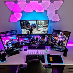 three computer monitors sitting on top of a desk