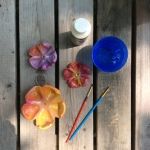 the table is set up with three different items on it, including an umbrella and paintbrushes