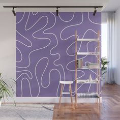 a purple wall with white lines on it and a ladder in the corner near a potted plant