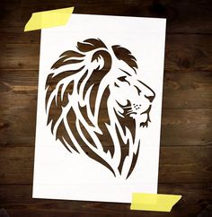 a paper cut out of a lion on top of a wooden table