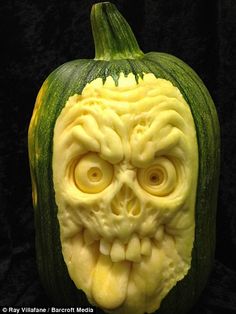 a carved pumpkin with an evil face on it's front and side, in the shape of a head