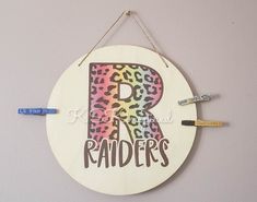 a wall hanging sign with the letter r painted on it