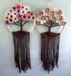 two decorative wall hangings with flowers on them