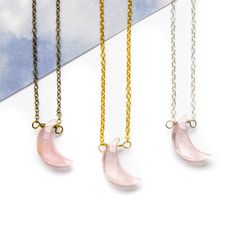 Introducing our enchanting Rose Quartz Moon Necklace, a celestial masterpiece that combines the captivating allure of the moon with the gentle, loving energy of Rose Quartz. Crafted with meticulous attention to detail, this exquisite necklace features a delicate rose quartz crescent moon pendant, suspended gracefully from a dainty chain. The moon's slender curves perfectly complement the soft, soothing hues of the Rose Quartz gemstone nestled at its center. Rose Quartz, known as the stone of unc Elegant Crystal Pendant Necklace With Moon Charm, Ethereal Necklace With Moon Charm For Gifting, Delicate Rose Quartz Crystal Necklace In Rose Gold, Delicate Half Moon Necklace With Moon Phase Detail, Delicate Half Moon Necklace With Moon Phase, Ethereal Moon Phase Necklace For Gift, Delicate Half Moon Phase Necklace, Ethereal Moon Phase Necklace Gift, Delicate Rose Gold Rose Quartz Crystal Necklace