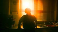 a person standing in front of a kitchen sink