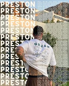 a man standing in front of a building with words all over his body and back