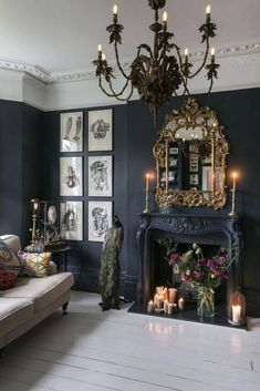 a living room with a fireplace and chandelier