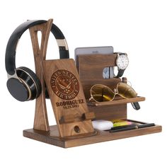 a wooden stand with headphones, sunglasses and cell phone on it that says richard