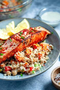 salmon and rice with lemon wedges on the side