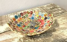 a decorative bowl sitting on top of a wooden table