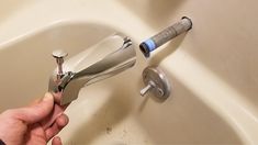 a person is fixing a faucet in a sink