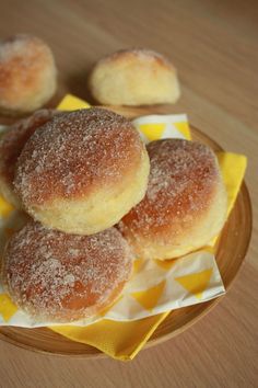 some sugared doughnuts are on a plate