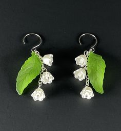 Discover the allure of our Lily of the Valley Earrings! These elegant earrings showcase a delicate Lily of the Valley floral design, gracefully hanging 2 inches from stainless steel earwires. Enjoy a comfortable fit with their lightweight and hypoallergenic materials, perfect for any occasion. Cute Charms, Pearl Charms, Lily Of The Valley, Elegant Earrings, The Valley, Jewelry Earrings Dangle, Etsy Earrings, Dangle Drop Earrings, Floral Design