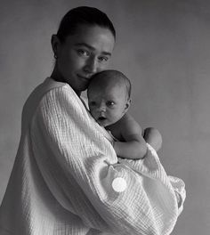 a woman holding a baby in her arms