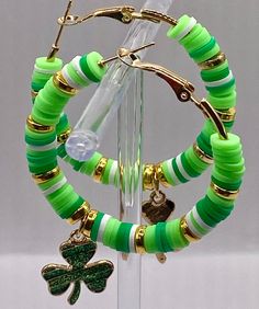 ☘️ St. Patrick's Day themed hoop earrings.  These gold toned hoops are 2 inches round and adorned with Green and White Heishi Beads with gold toned findings, added 2 beautiful charm clovers ☘️ for luck and a little bit of bling!  Thank you for supporting a veteran owned business! ❤️ Charms Earrings, Womens Earrings, Clover Charm, Heishi Beads, Saint Patrick, Jewelry Earrings Hoops, Beads Jewelry, Charm Earrings, Earring Gifts