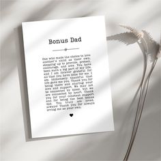 a piece of paper with the words'bonus dad'written on it next to a plant