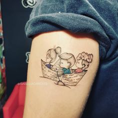 a couple in a boat tattoo on the right thigh