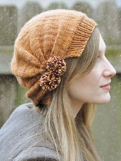 a woman with long hair wearing a knitted hat